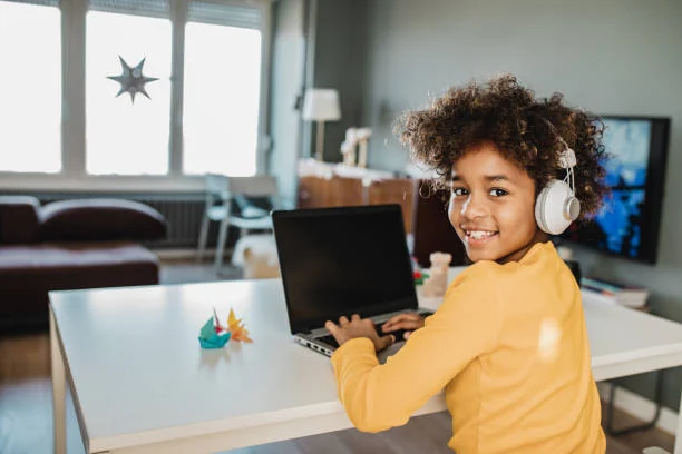 A girl in a lesson at her laptop at home