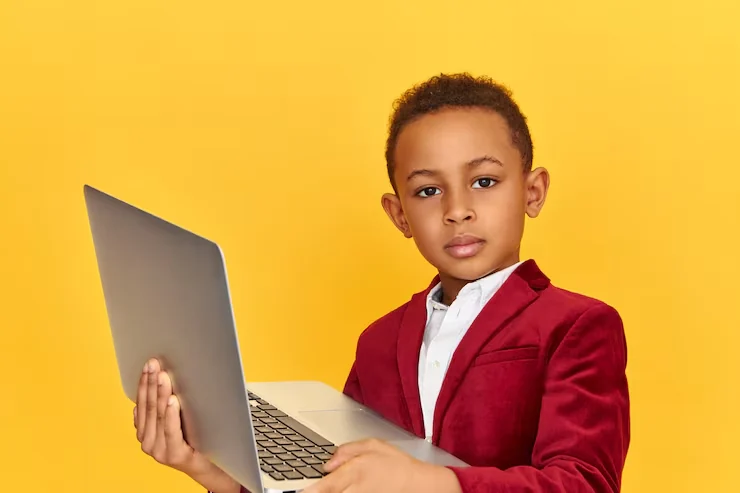 A boy at his laptop, ready for his lesson